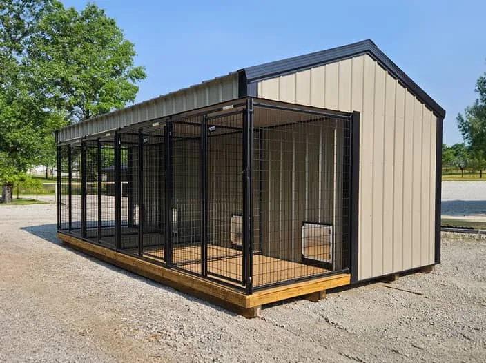 Beige dog kennel with black trim and multiple outdoor runs on a gravel lot