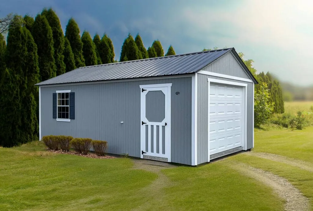Light gray Elite Garage with white trim, overhead garage door, side entry door, and window on a grassy lot