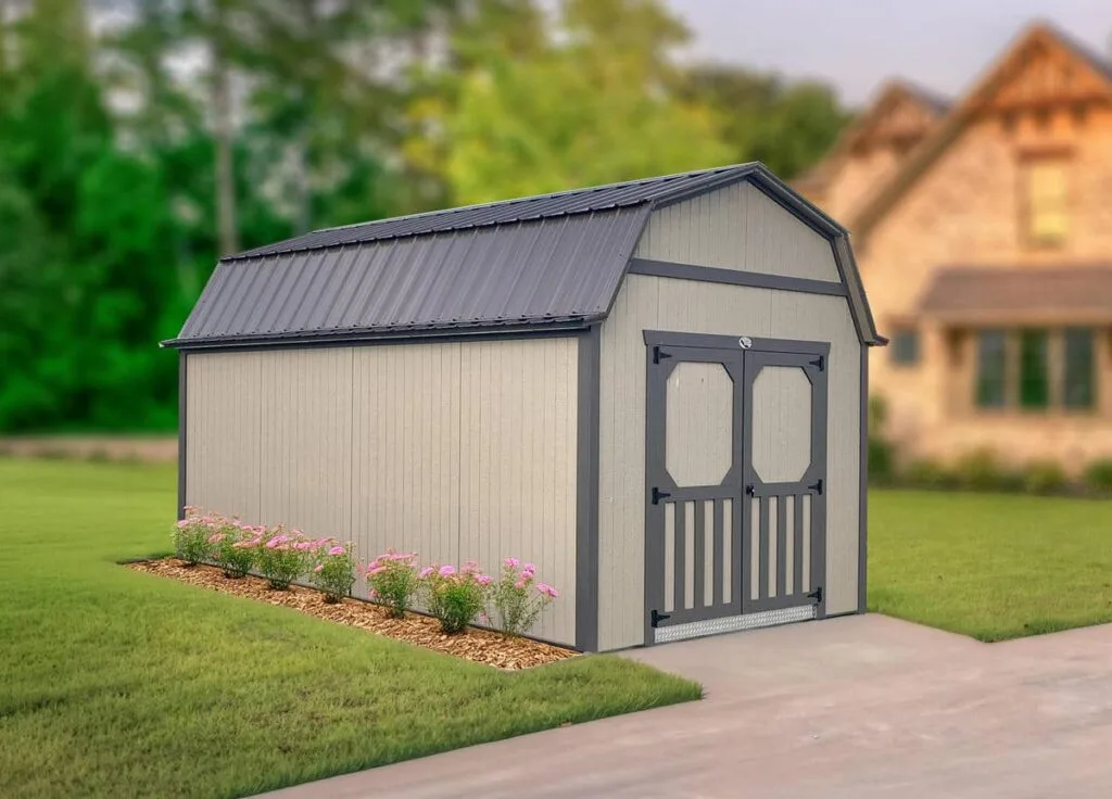 Beige Elite Lofted Barn with gray trim and double doors beside a residential lawn