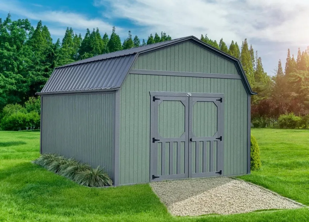 Green Elite Lofted Barn with gray trim and double doors on a grassy lot