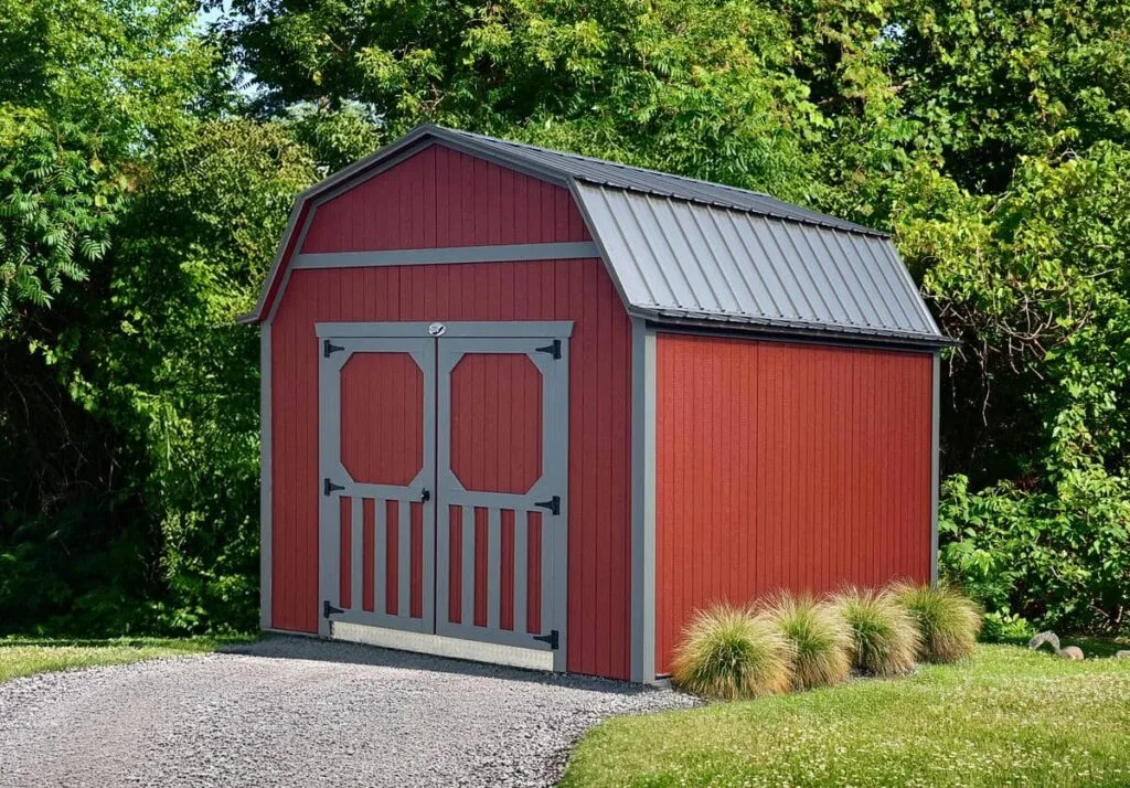 Red Elite Lofted Barn with gray trim and double doors in a landscaped yard